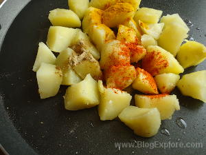 adding spices for tawa potato masala