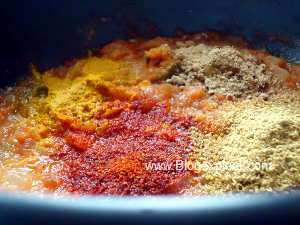 adding spices for kala chana masala curry