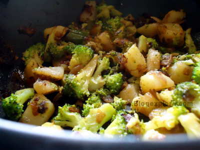 stir frying broccoli and potatoes for broccoli salad
